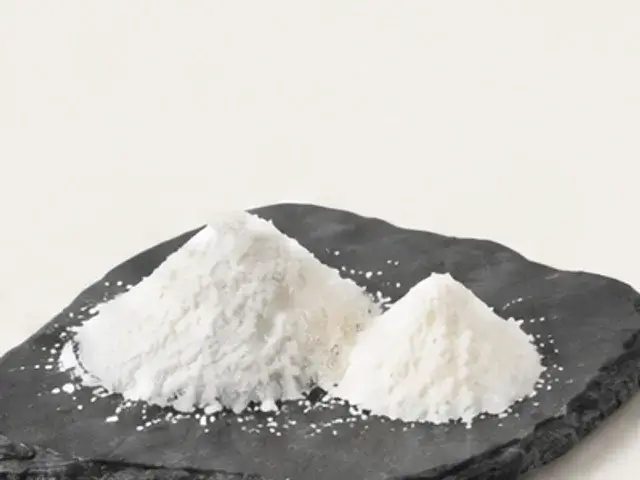 Two white powders on a slate